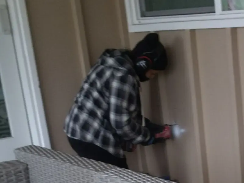 Professional electrician installing an exterior outlet in Camanche